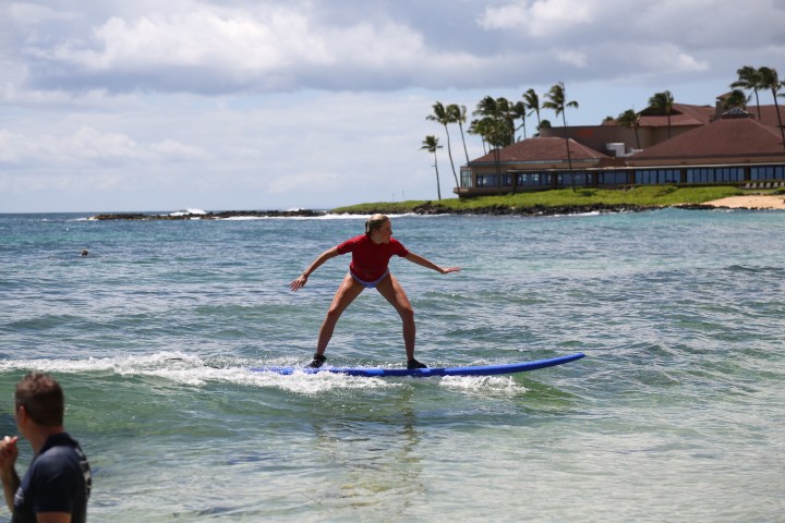 girl surfing into shore