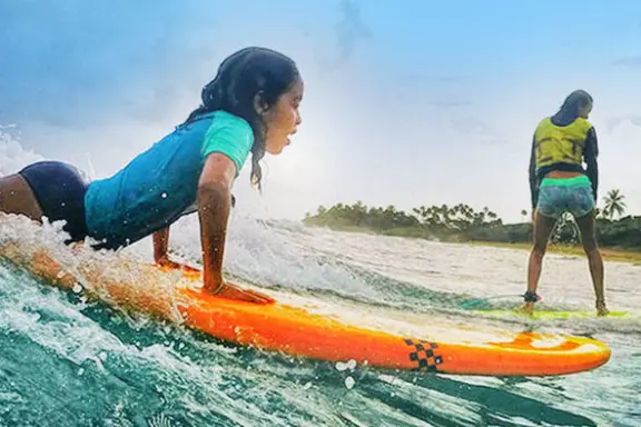 sisters learning to surf on rentals