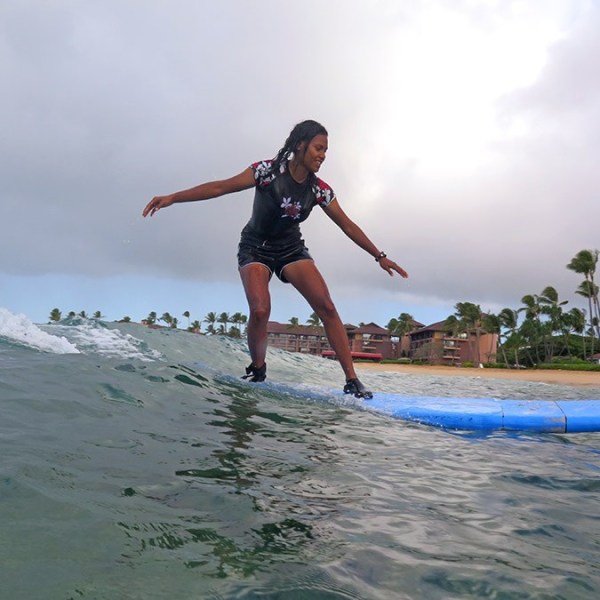 girl leaning back on surfboard
