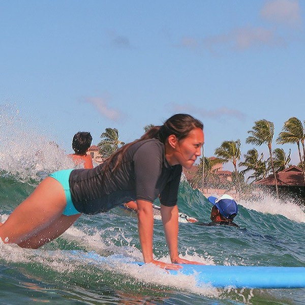 girl popping up to her knees surfing